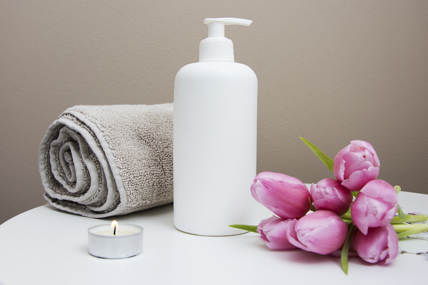 Warm stones and orchids set out for a calming facial suite prepared for a bridal client